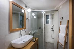 a bathroom with a sink and a shower at Loggia Suites by Good Life in Heraklio