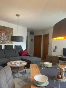 a living room with a couch and a table at Appartements Sonntal Einkehr in Fieberbrunn