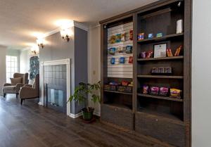 a living room with a large wooden book shelf at Quality Inn & Suites in Tulare