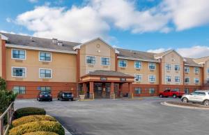 a large building with cars parked in a parking lot at Extended Stay America Suites - Kansas City - South in Kansas City