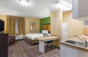 Habitación de hotel con cama y lavabo en Extended Stay America Suites - Kansas City - Airport en Kansas City