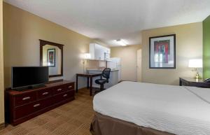 a hotel room with a bed and a flat screen tv at Extended Stay America Suites - Sacramento - White Rock Rd in Rancho Cordova