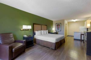 a hotel room with a bed and a chair at Extended Stay America Suites - Phoenix - Scottsdale - North in Scottsdale