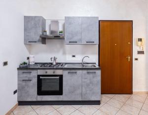 uma cozinha com um lavatório e um fogão forno superior em Alloggio Alfa em Civitavecchia