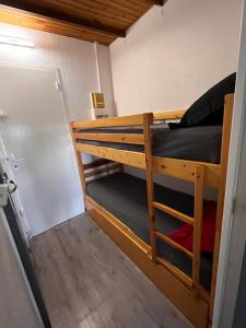a bunk bed in a small room with a door at 46 Île Paradise Vue Port in Cap d'Agde