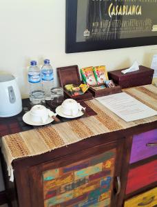 a table with two plates and water bottles on it at Casa De Amed in Amed