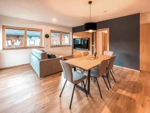 a dining room with a table and chairs and a couch at RUHESTUBE - AlpenLuxus Collection in Fügen