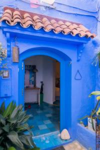 a blue house with a tile roof at DAR DAUIA in Chefchaouen