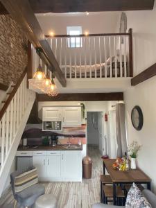 a kitchen and a living room with a staircase at The Casan in Letterkenny