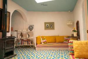 a living room with a couch and a fireplace at DAR DAUIA in Chefchaouen
