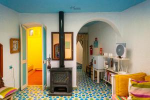 a living room with a wood stove in a room at DAR DAUIA in Chefchaouen