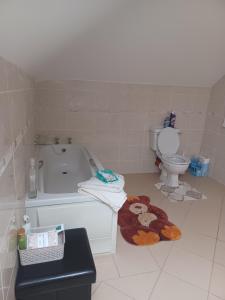 a bathroom with a bath tub and a toilet at Country Haven eircode H54 AK31 in Galway