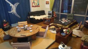 a living room with a table and a couch at Guesthouse Oomiya base 大宮基地別荘 in Chiba