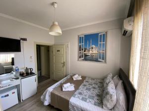 a hotel room with a bed and a window at Marina Hotel in Amasra