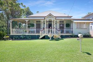 a house with a porch and a yard at A Charming Queenslander in Bundaberg
