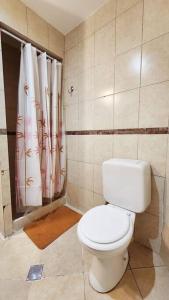 a bathroom with a toilet and a shower curtain at Espectacular departamento para 6 personas. in Buenos Aires