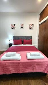 a bedroom with a large bed with two towels on it at Espectacular departamento para 6 personas. in Buenos Aires