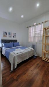 a bedroom with a bed with blue sheets and a ladder at Espectacular departamento para 6 personas. in Buenos Aires