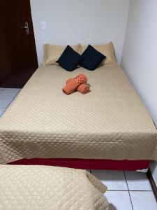 a bed with two stuffed animals sitting on it at Lindo quarto próximo ao metrô ! in Sao Paulo