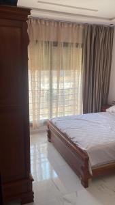 a bedroom with a bed in front of a window at Apartment Nador in Nador