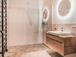 a bathroom with a sink and a shower at AlpenLuxus' CHEZ NOUS with balcony & car park in Fügen