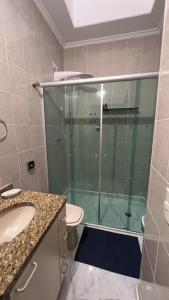 a bathroom with a shower with a toilet and a sink at Lindo quarto próximo ao metrô ! in São Paulo