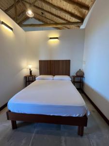 a bedroom with a large bed in a room at A Fonte in Santo António