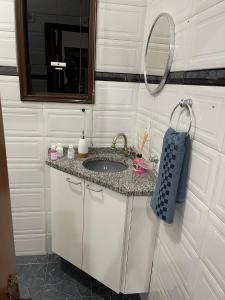 a bathroom with a sink and a mirror at Suíte Próxima Ao Metrô Penha !!! in Sao Paulo