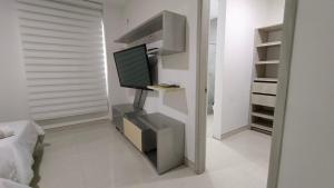 een woonkamer met een tv op een plank bij Hotel Kai in Uribia