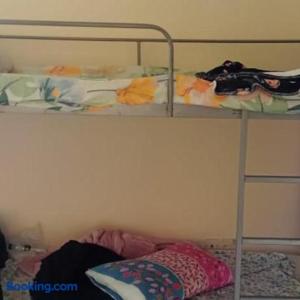 a bunk bed with a ladder and a pillow on the bottom shelf at Dormitory bed space in a shared room in Sharjah