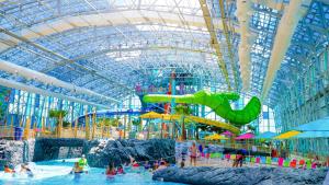 a water park with a water slide in a building at 5 Star 4/3 sleeps 16 with Arcade GAME ROOM & POOL! in Orange Beach