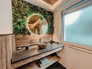 a bathroom with a sink and a mirror at AlpenLuxus' OLDWOOD CHALET with balcony & car park in Fügen