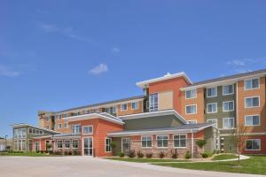 a row of apartment buildings on a street at Residence Inn by Marriott Cedar Rapids South in Cedar Rapids