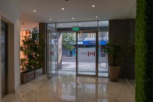 an entrance to a building with a sign on the door at MIRAFLORES CITY HOTEL in Lima