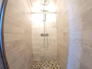 a shower with a shower head in a bathroom at bnbgônes -LE RILLARD- Rillieux - Proche Lyon - WIFI in Rillieux +14 photos