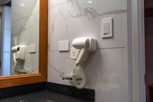 a phone on a wall in a bathroom at MIRAFLORES CITY HOTEL in Lima