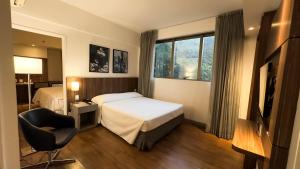 Cama ou camas em um quarto em Hotel Vivenzo Savassi Belo Horizonte