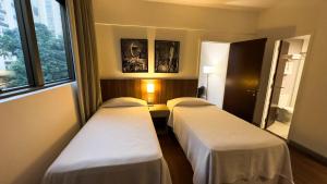 Cama ou camas em um quarto em Hotel Vivenzo Savassi Belo Horizonte