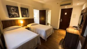Cama ou camas em um quarto em Hotel Vivenzo Savassi Belo Horizonte