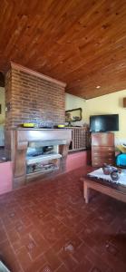 a living room with a piano and a table at Casa Gelsi - El Cadillal in Tafí Viejo