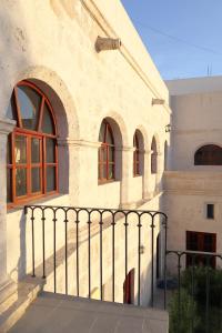 a building with a fence in front of it at Estancia El Solar in Arequipa