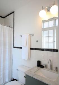 a bathroom with a toilet and a sink and a window at StayRafa At 253 3F in Philadelphia