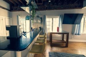 a kitchen with a counter and a table and chairs at StayRafa At 253 3F in Philadelphia