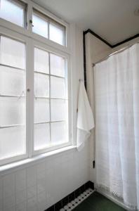 a shower with a window and a shower curtain at StayRafa At 253 3F in Philadelphia