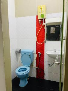 a bathroom with a blue toilet and a sink at Hotel City Bukit Bintang in Kuala Lumpur