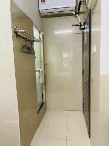 a bathroom with a shower and a glass door at Hotel City Bukit Bintang in Kuala Lumpur