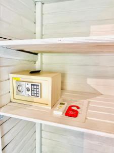 a small microwave sitting on top of a shelf at Tarci Bungalows Lembongan in Nusa Lembongan +58 photos