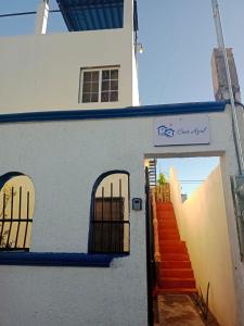 a white building with doors and stairs on it at Casa Azul in La Paz +27 photos