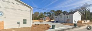 a white building with a house next to it at SC 3755 New 2 bedroom Townhouse Ft Jackson & USC in Columbia