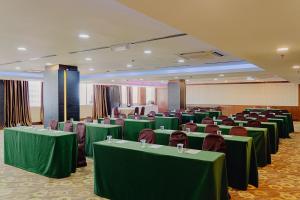 a conference room with green tables and chairs in it at Hotel Sentral Melaka @ City Centre in Melaka